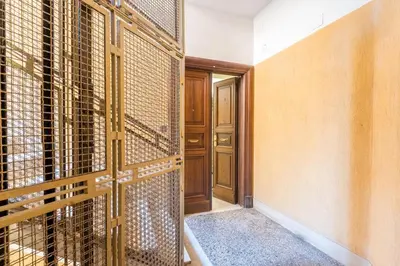 an empty room with a door and a room with a gate at B HOUSE - luxury apartment Trastevere in Rome