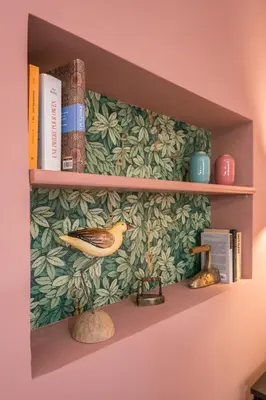 a book shelf with a bird and books at B HOUSE - luxury apartment Trastevere in Rome