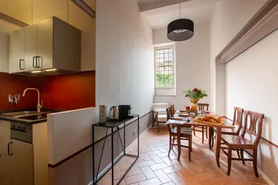 a kitchen and dining room with a table and chairs at Colosseum Suites - Zen 22 in Rome