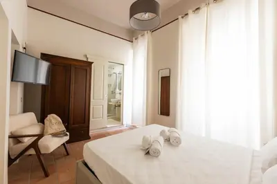 a bedroom with a bed with towels on it at Colosseum Suites - Zen 22 in Rome
