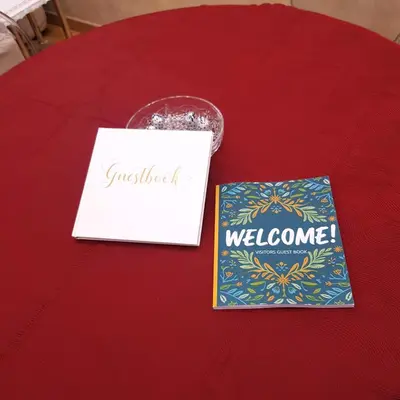 a red table with a sign and a welcome packet at Chez Pierre tourist rental in Rome