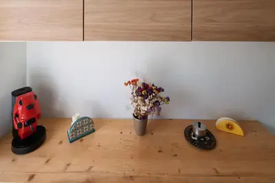 a table with a vase of flowers on a counter at Pigneto Apartment in Rome