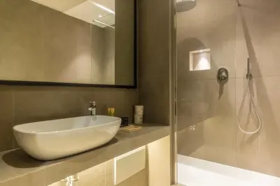a bathroom with a white sink and a shower at Spiriti Home Apartment , New Opening Piazza di Pietra in Rome