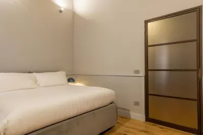 a bedroom with a white bed and a closet at Spiriti Home Apartment 2, New Opening Piazza di Pietra in Rome