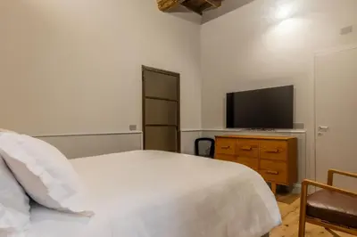 a bedroom with a bed and a flat screen tv at Spiriti Home Apartment 2, New Opening Piazza di Pietra in Rome