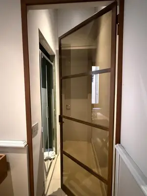 a glass cabinet in a room with a door at Spiriti Home Apartment 3, New Opening Piazza di Pietra in Rome