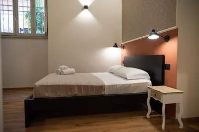 a bedroom with a large bed and a table at By Lina in Trastevere in Rome