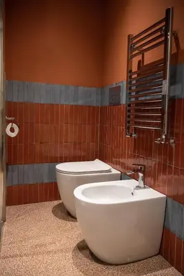 a bathroom with a white toilet and a sink at By Lina in Trastevere in Rome