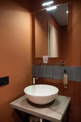 a bathroom with a large white sink and a mirror at By Lina in Trastevere in Rome