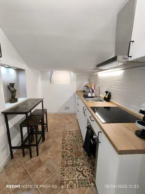 a kitchen with a table and a counter top at Maison Vittoria in Rome