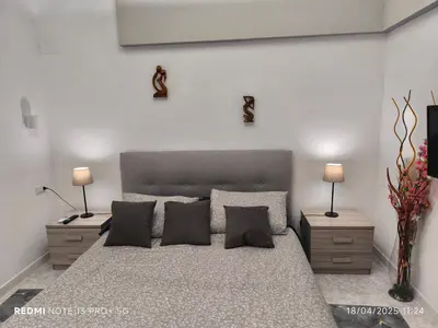 a bedroom with a large bed with two night stands at Maison Vittoria in Rome