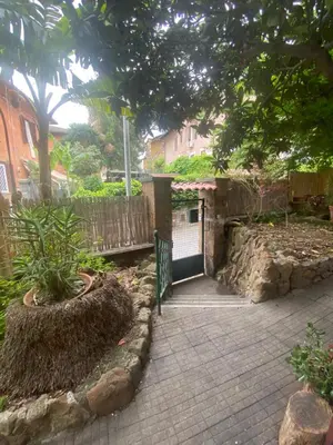 a walkway leading to a gate in a garden at Villetta Garbata in Rome