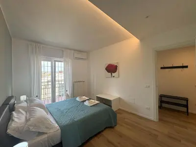 a bedroom with a bed and a large window at Sunny Stay with a Roman Soul in Rome