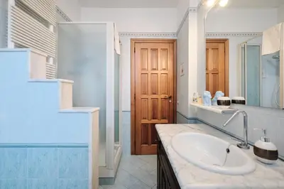 a bathroom with a sink and a mirror at Metro A 10 minutes - Free Wi-Fi & Netflix in Rome
