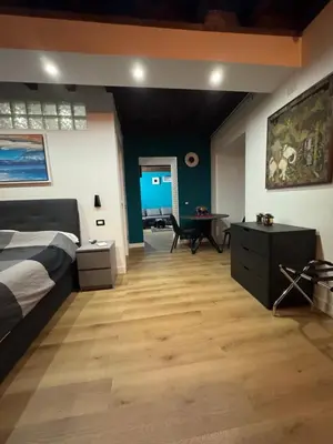 a bedroom with a bed and a desk in a room at Elephant Parliament Apt in Rome