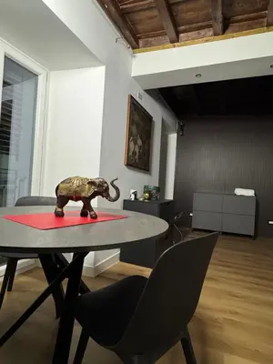a table with a toy elephant on a red rug at Elephant Parliament Apt in Rome