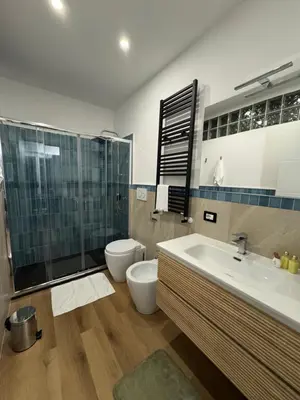 a bathroom with a sink and a toilet and a shower at Elephant Parliament Apt in Rome