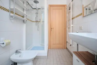 a bathroom with a sink and a toilet and a shower at Tuscolana Station - 10 minutes from Metro A in Rome