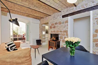 a living room with a vase of flowers on a table at YCH-Laterano Charme in Rome