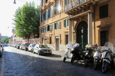 a row of motorcycles parked next to a building at YCH-Laterano Charme in Rome