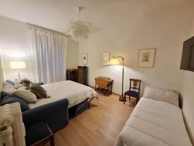a bedroom with a bed and a couch and a table at Appartamento viale Mazzini in Rome