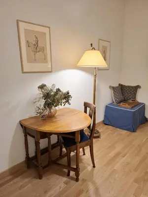 a room with a table and a lamp and a couch at Appartamento viale Mazzini in Rome