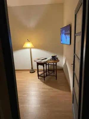 a room with a table and a lamp in it at Appartamento viale Mazzini in Rome