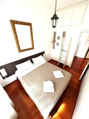 a bedroom with a bed with white pillows and a mirror at Vatican Home - San Pietro - Near to Metro A in Rome
