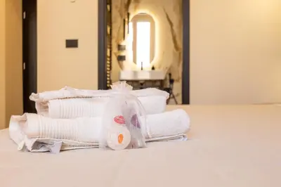 a pile of white towels sitting on a table at Minerva Boutique Suites in Rome