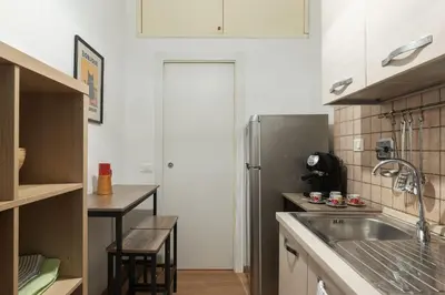 a small kitchen with a stainless steel refrigerator at GuestHost - Roma Termini Lovely Flat in Rome