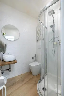 a bathroom with a shower and a toilet and a sink at NOSTROMONDO-Elegant Suite with patio in Monti Parioli in Rome