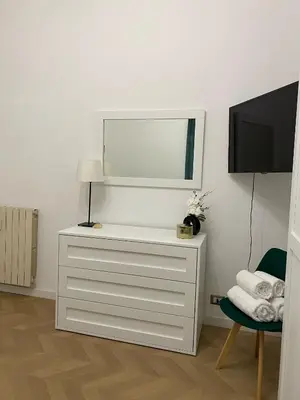 a white dresser with a mirror and a tv at Bart Rome House in Rome