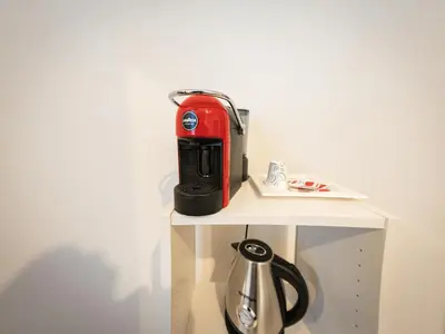 a red toaster sitting on top of a shelf at La Stella di Roma al Vaticano in Rome
