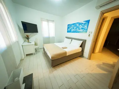 a small bedroom with a bed and a television at La Stella di Roma al Vaticano in Rome