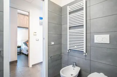 a bathroom with a toilet and a sink at Battistini Pretty Apartment in Rome