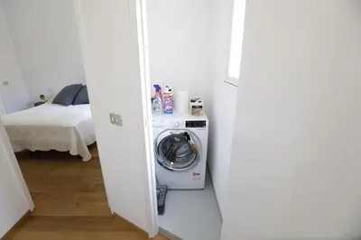 a room with a washing machine and a bed at Colosseum Panoramic Terrace in Rome