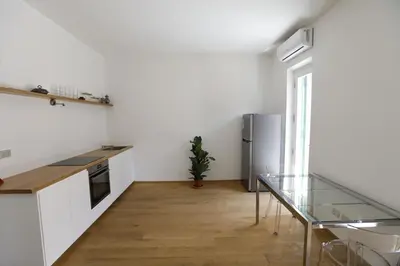 a kitchen with a glass table and a refrigerator at Colosseum Panoramic Terrace in Rome