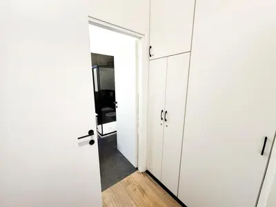 a hallway with white cabinets and a door at Urban Loft 55 in Rome