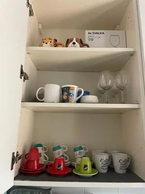 a cupboard filled with lots of cups and dishes at Residenza Tulipano in Rome