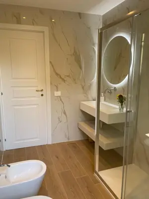 a bathroom with a sink and a mirror at Vatican deluxe apartment - Casa Cesarina in Rome
