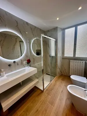 a bathroom with a sink and a tub and a mirror at Vatican deluxe apartment - Casa Cesarina in Rome