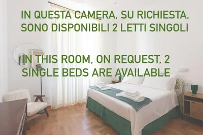 a bedroom with a bed in a room with a chair at Vatican deluxe apartment - Casa Cesarina in Rome