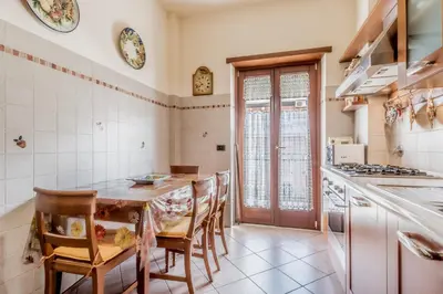 a kitchen with a wooden table and chairs at Casa da Annarella in Rome