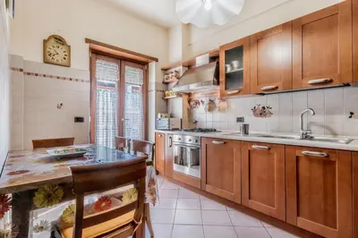 a kitchen with wooden cabinets and a counter top at Casa da Annarella in Rome