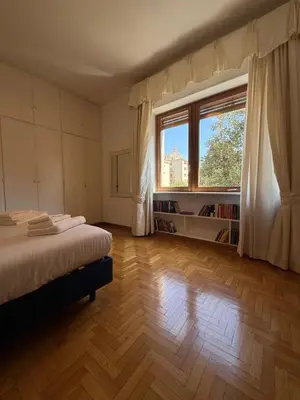 a bedroom with a bed and a large window at St Peter Rooms with Private Parking by Dama in Rome