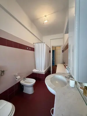 a bathroom with two sinks and a toilet and a shower at St Peter Rooms with Private Parking by Dama in Rome