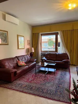a living room with two brown leather couches and a rug at St Peter Rooms with Private Parking by Dama in Rome