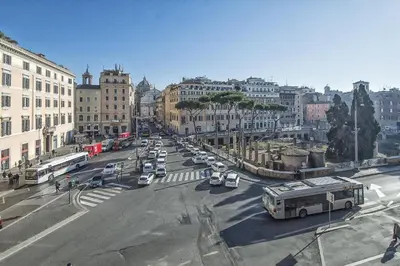 a busy city street with cars and a bus at Little Queen Relais in Rome