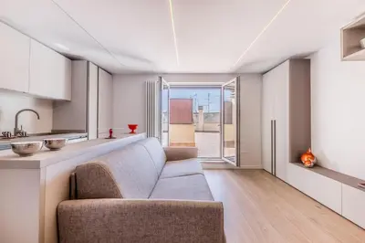 a living room with a couch and a kitchen at APT ROME Sergio I - San Pietro Vatican in Rome
