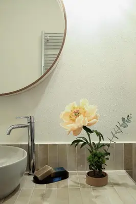 a bathroom with a sink and a flower on a counter at Flowers Rooms - Ponte Milvio in Rome